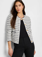 Cream & navy knit jacket with fine grid pattern, collarless, dark trim, and gold buttons.