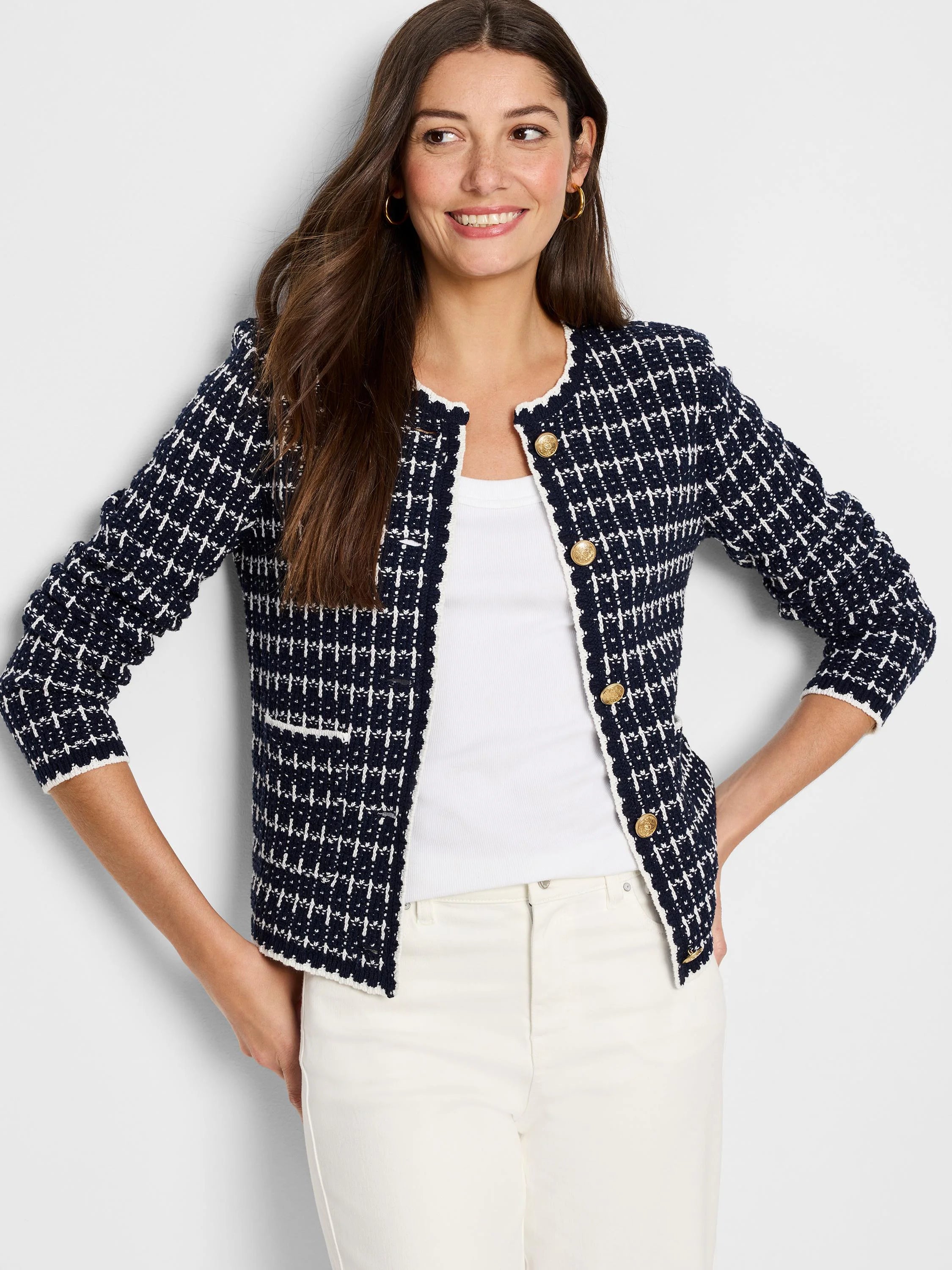 Collarless navy and white tweed sweater jacket with gold buttons and white scalloped trim.