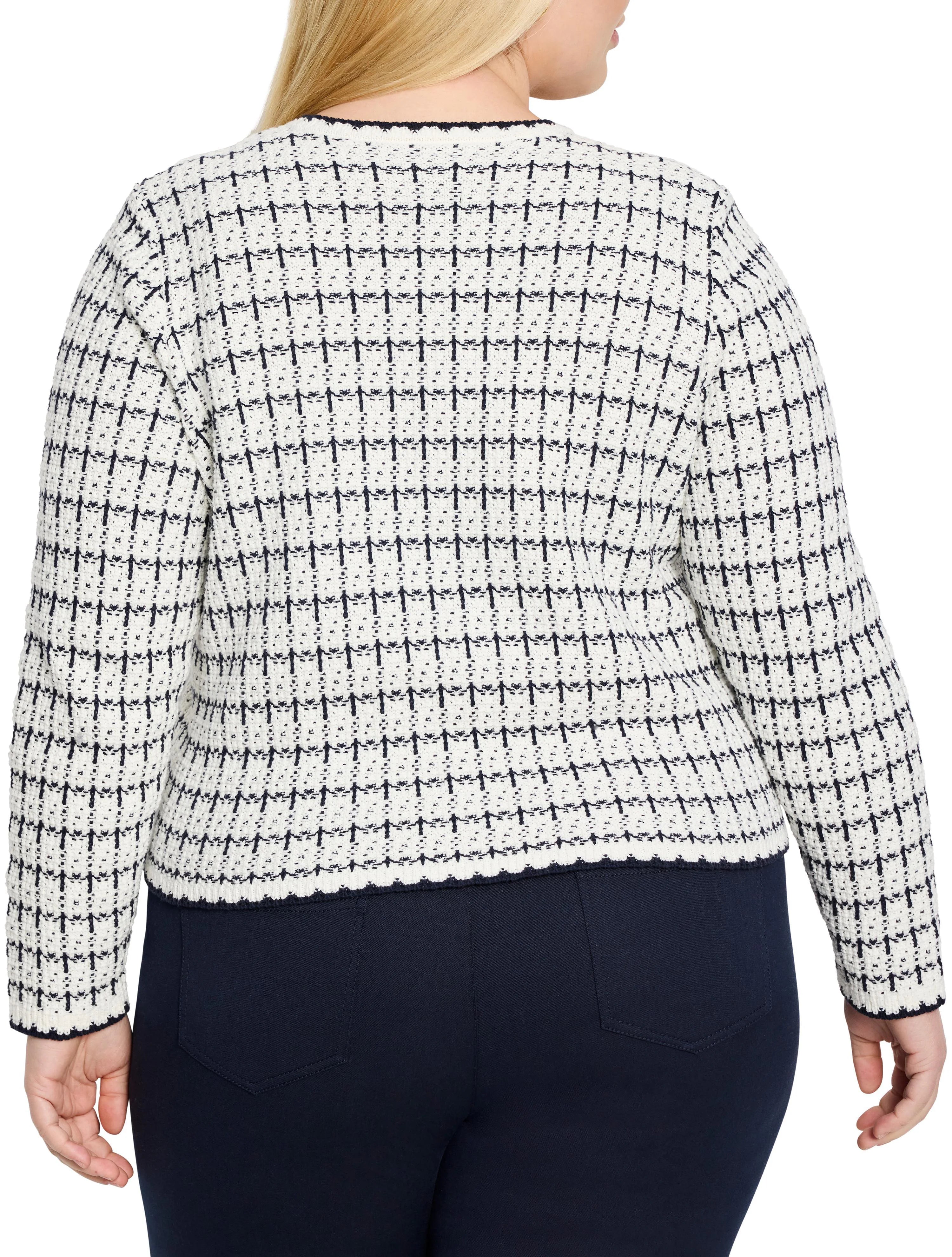 Off-white sweater jacket with navy textured grid pattern, ribbed dark blue collar, cuffs, and hem. Back view.