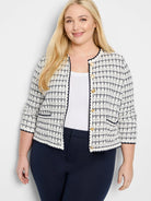 Cream and navy bouclé jacket with a grid pattern, gold buttons, navy scalloped trim, and 3/4 sleeves.