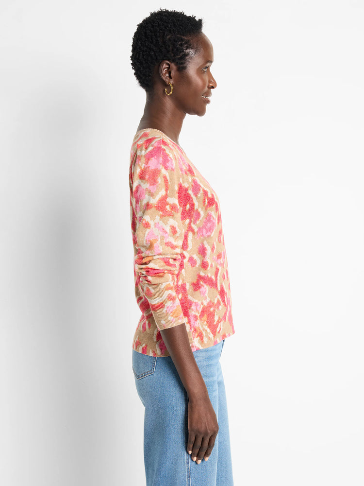 Beige sweater with pink and red ikat pattern. Long sleeves, V-neck.