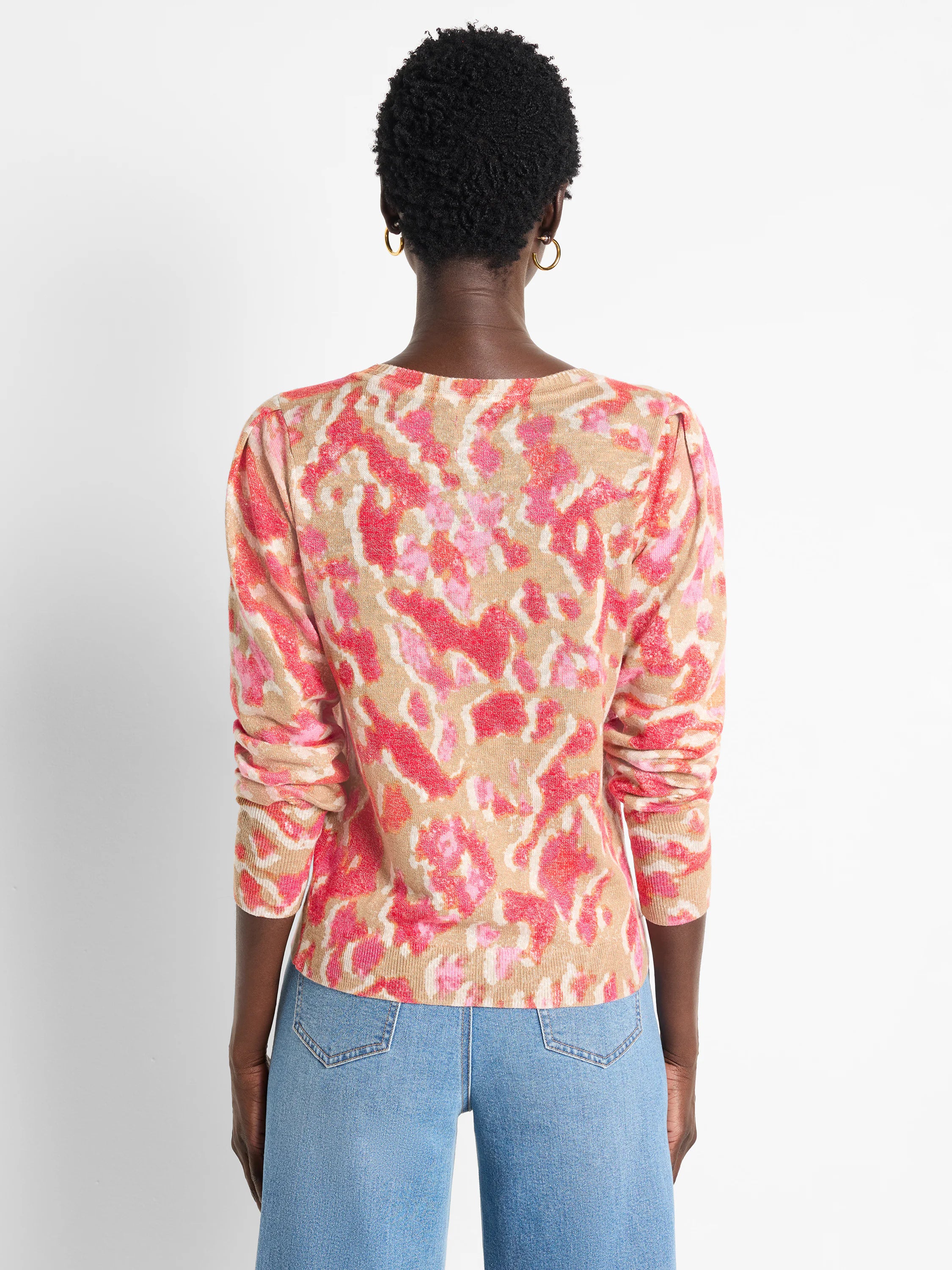 Pink, beige, and white Ikat pattern long-sleeve sweater.  Back view.