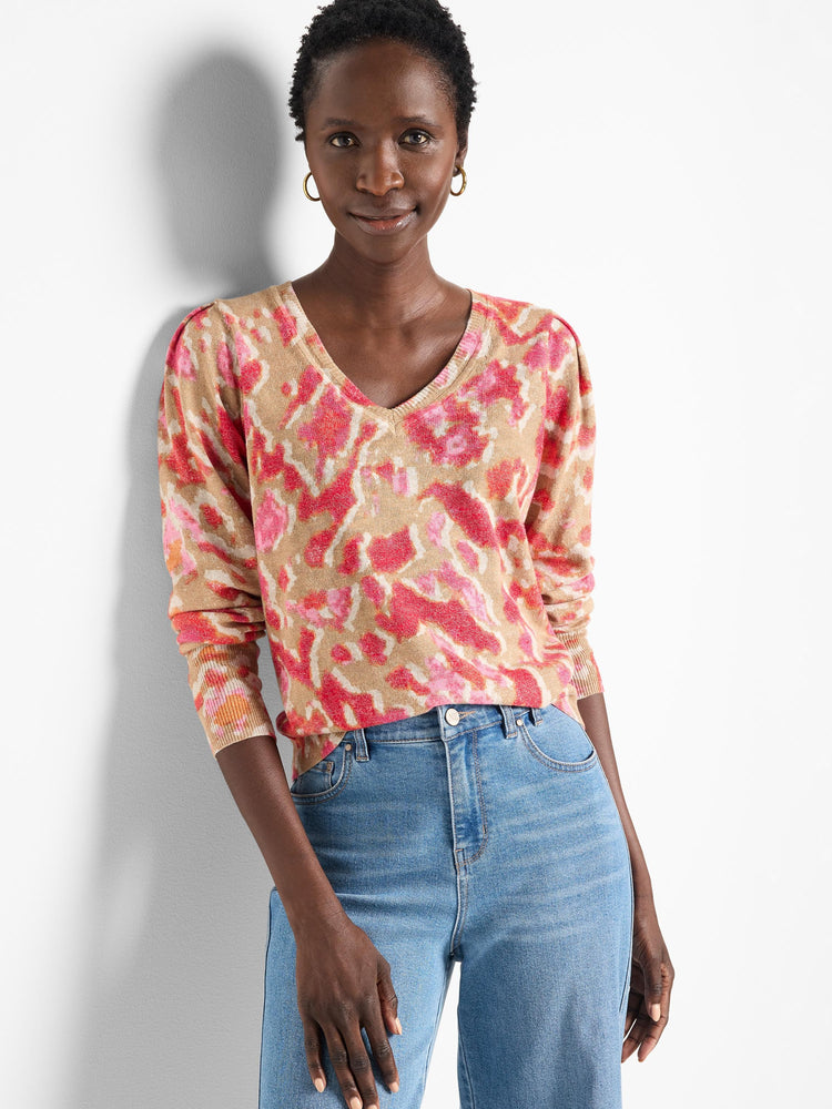 Beige sweater with pink and orange ikat pattern. V-neck, long sleeves.