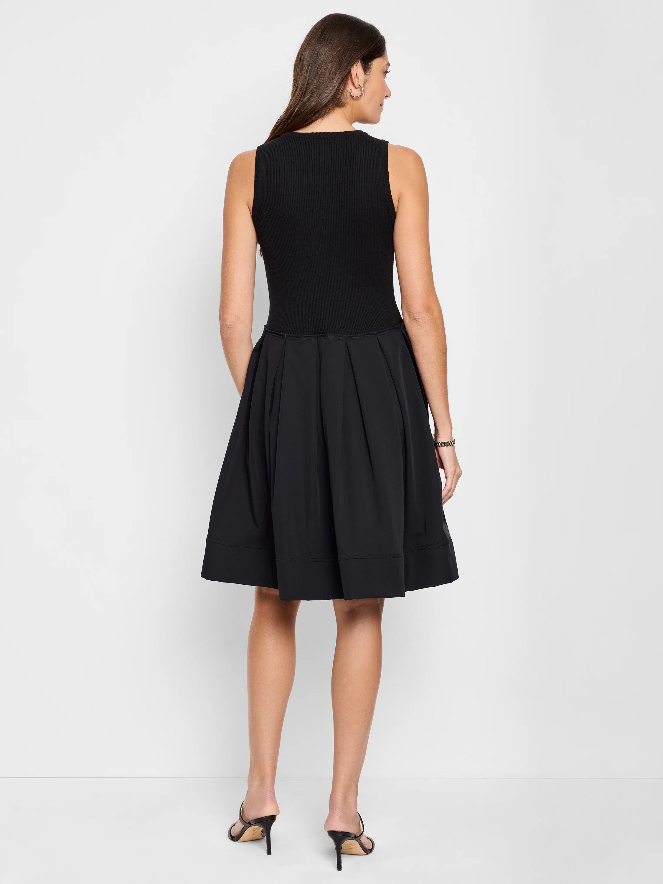 Black sleeveless ribbed knit top and pleated A-line skirt midi dress.