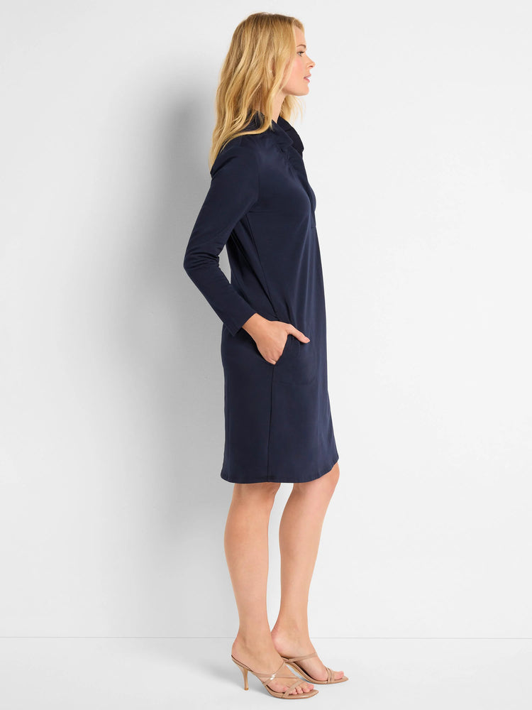 Navy blue knit dress, 3/4 sleeves, ruffled neckline, knee-length, side pockets.