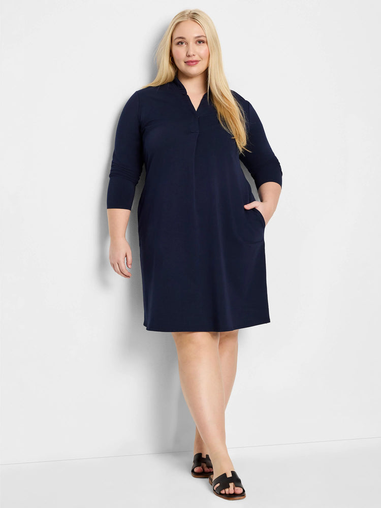 Navy blue, knee-length knit dress. Three-quarter sleeves, V-neck, and side pockets.
