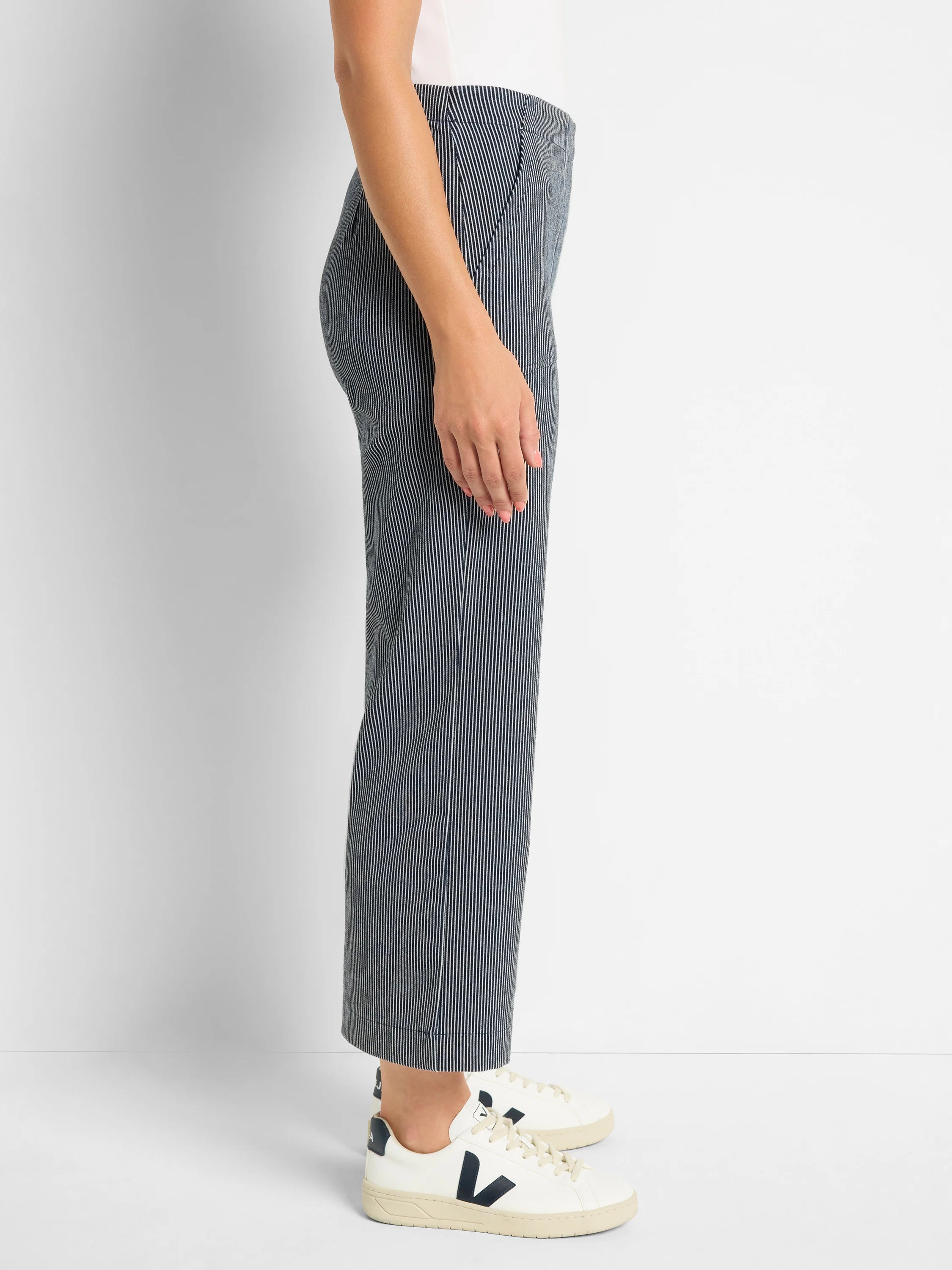 Side view of navy wide-leg jeans with thin white vertical stripes.