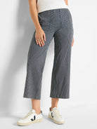 Navy and white vertical stripe wide-leg jeans, cropped above the ankle.