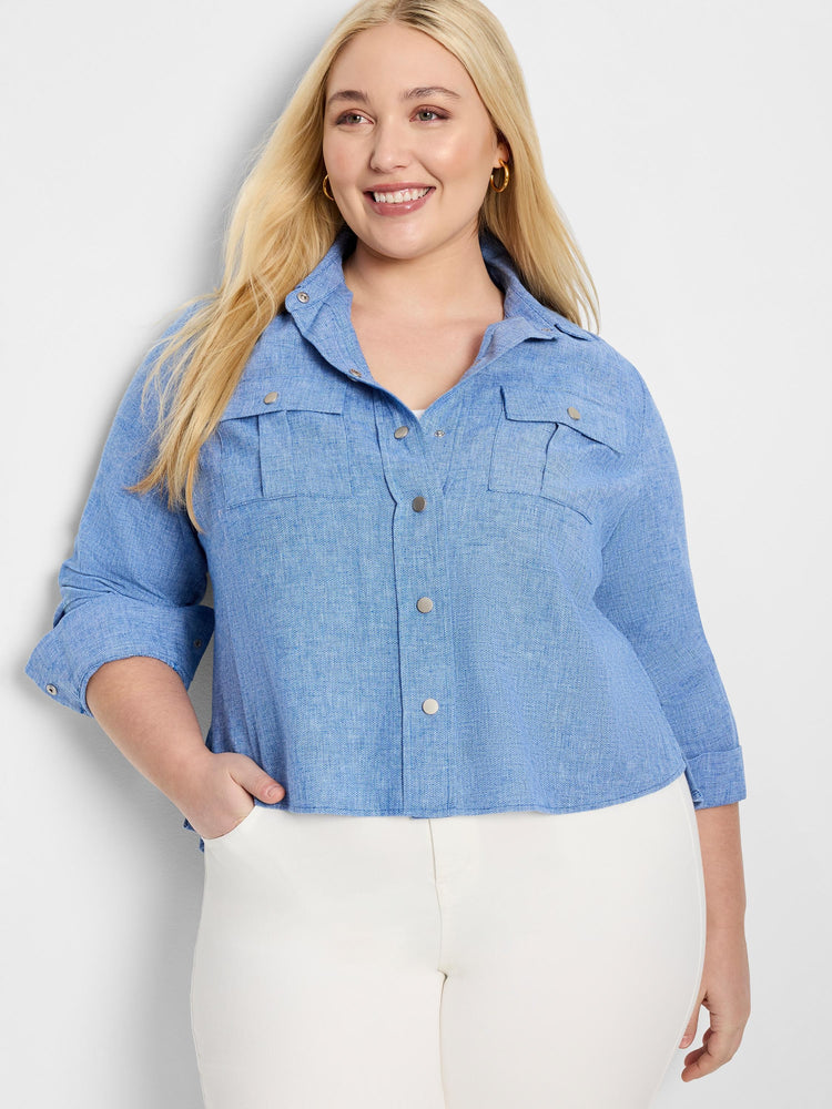 Light blue, textured shirt jacket with three-quarter sleeves, button front, and two chest pockets. Silver buttons.