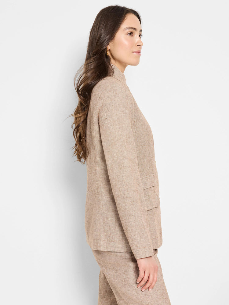 Beige linen-cotton blazer. Side view shows textured fabric, long sleeves, and a collared neckline.