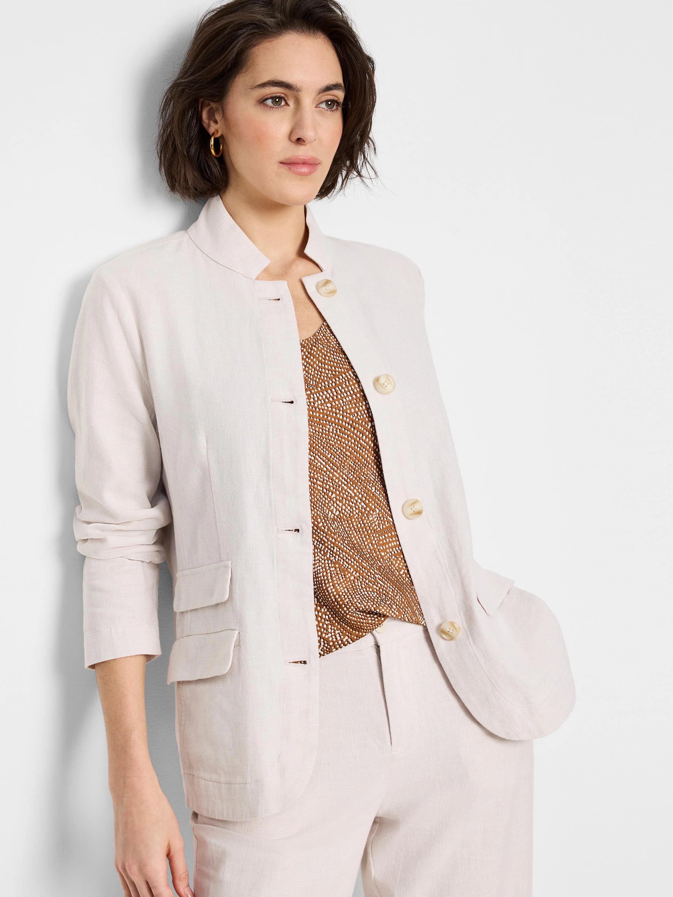 Off-white linen-cotton blazer,  four buttons, notched collar,  patch pockets.