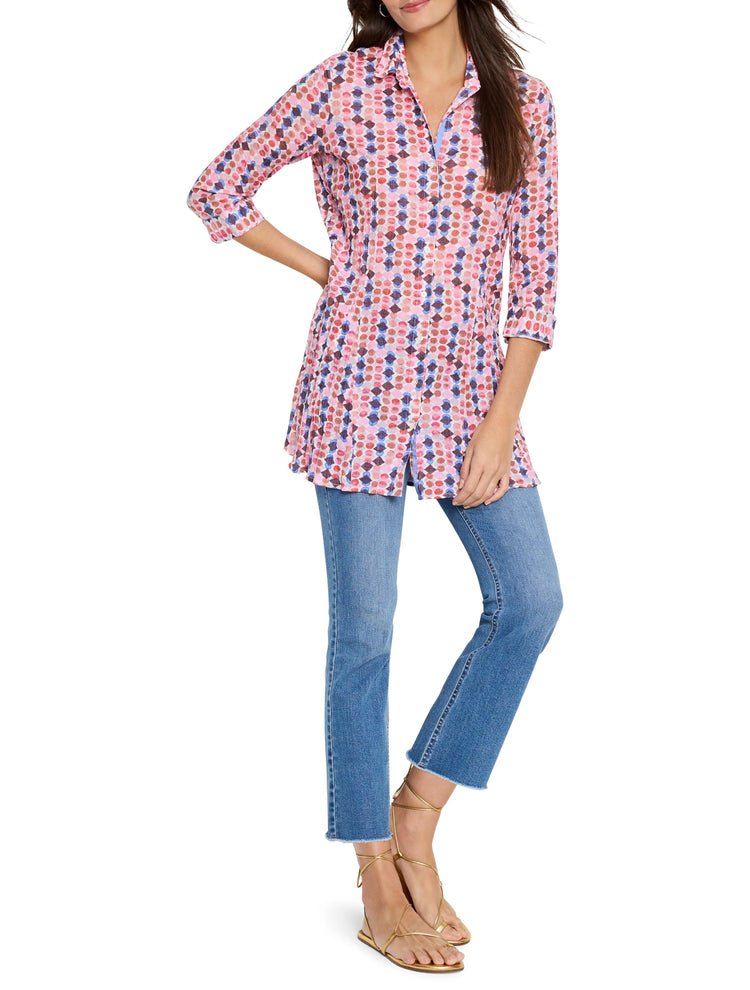 Long-sleeved collared shirt, pink base with repeating pattern in pink, red, blue, and brown. A-line shape.
