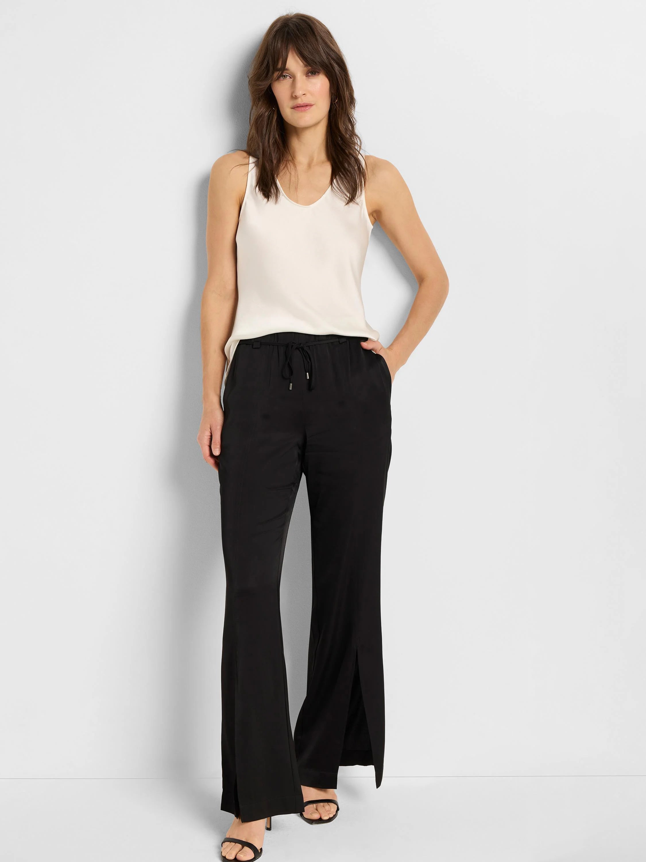 Black wide-leg pants with side slits, drawstring waist. Model wears off-white camisole.