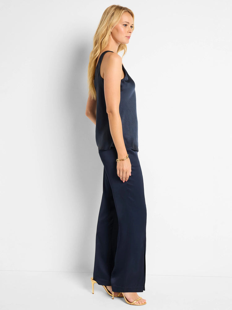 Navy blue scoop-neck tank top, shiny satin fabric. Model wears matching navy pants.