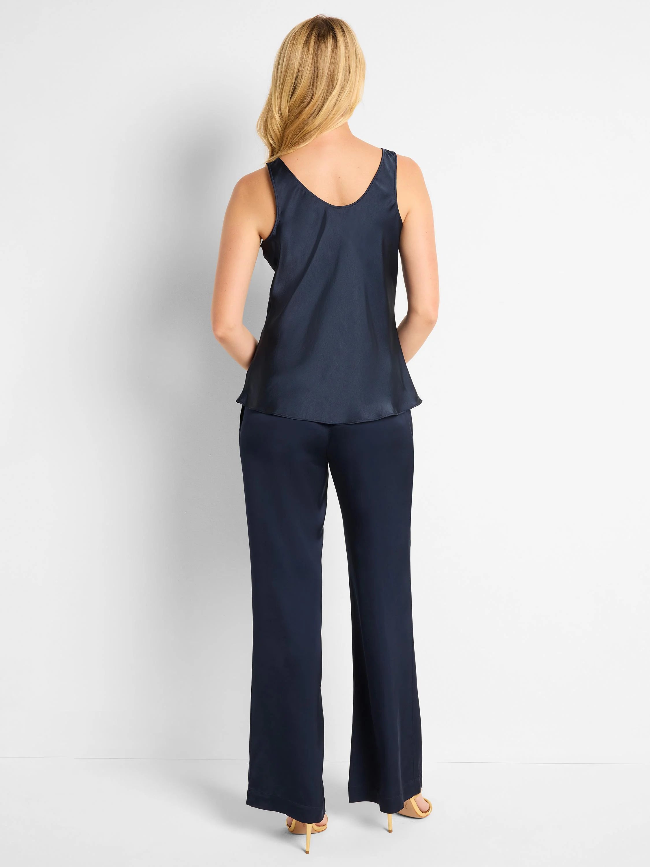 Here's alt text for the image, under 125 characters:
"Navy blue scoop-neck tank and wide-leg pants. The outfit is shown...