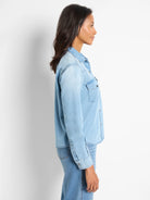 Light blue denim shirt, long sleeves, button front, chest pockets.