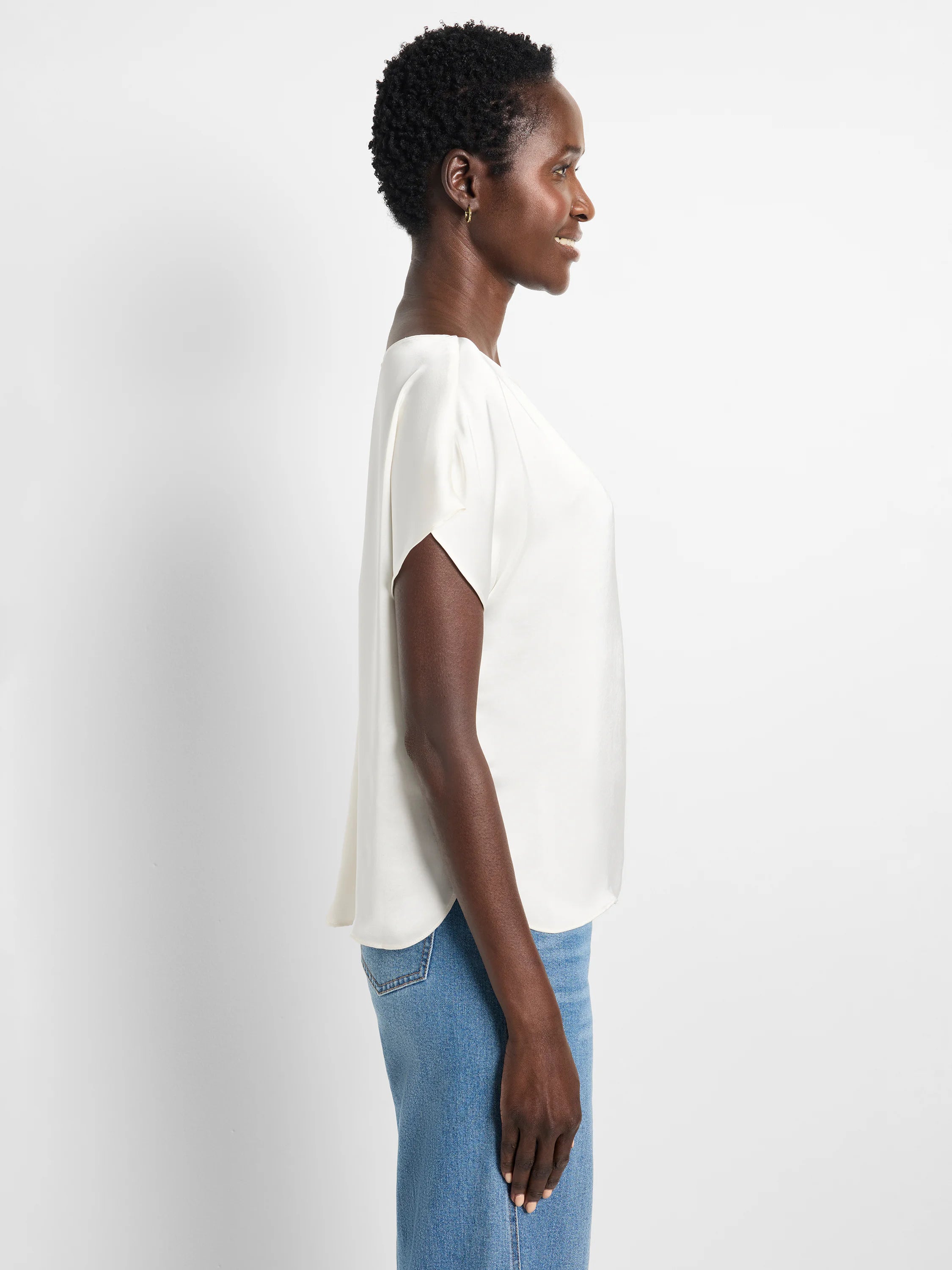 Light cream woven tee with wide neckline and draped short sleeves. Flowy fit.