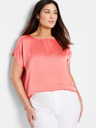 Coral pink, short-sleeved woven top with boat neck.  Shiny, satin-like texture.