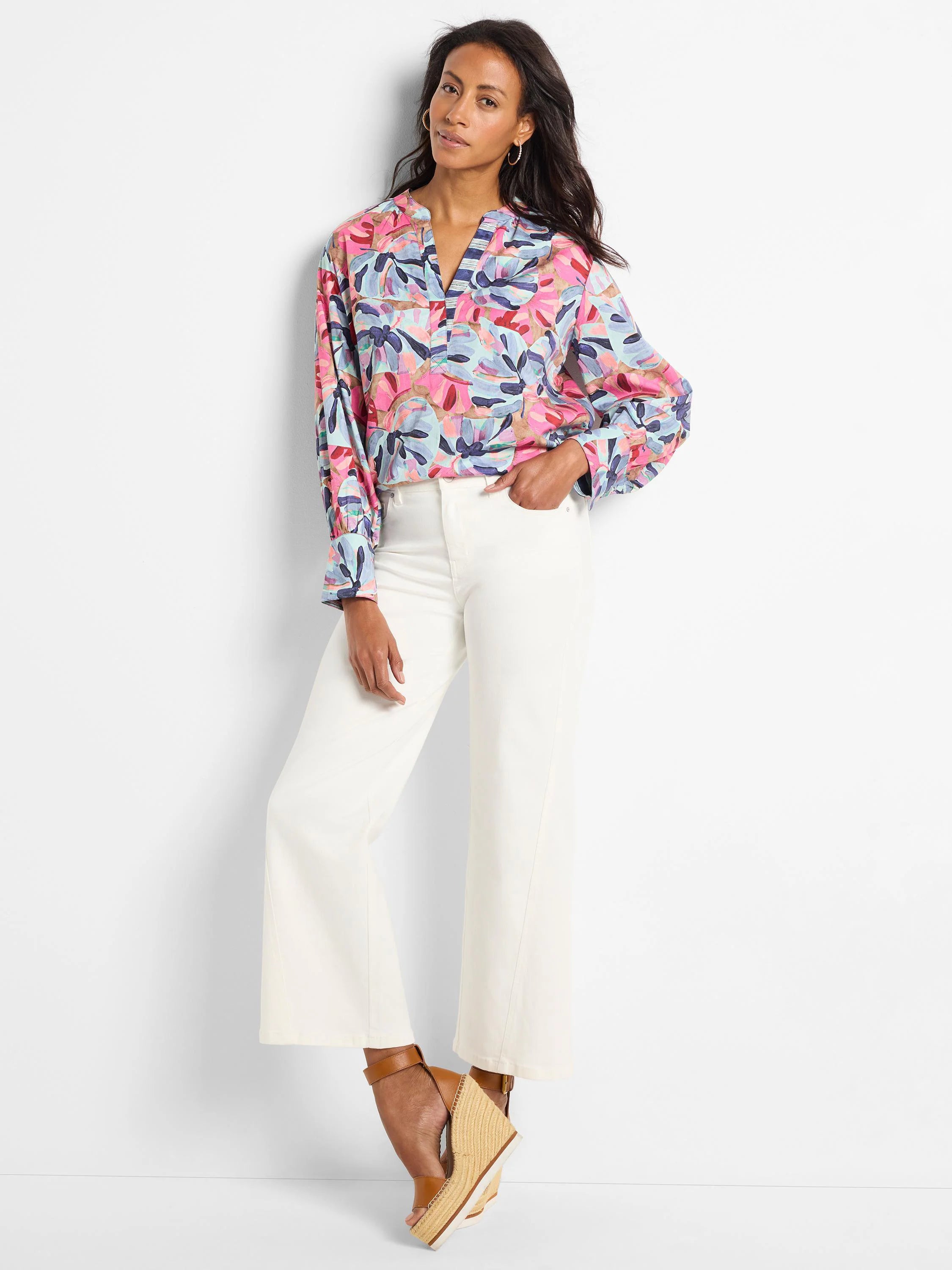 Pink, blue, and purple abstract floral print woven top with long sleeves and V-neck.