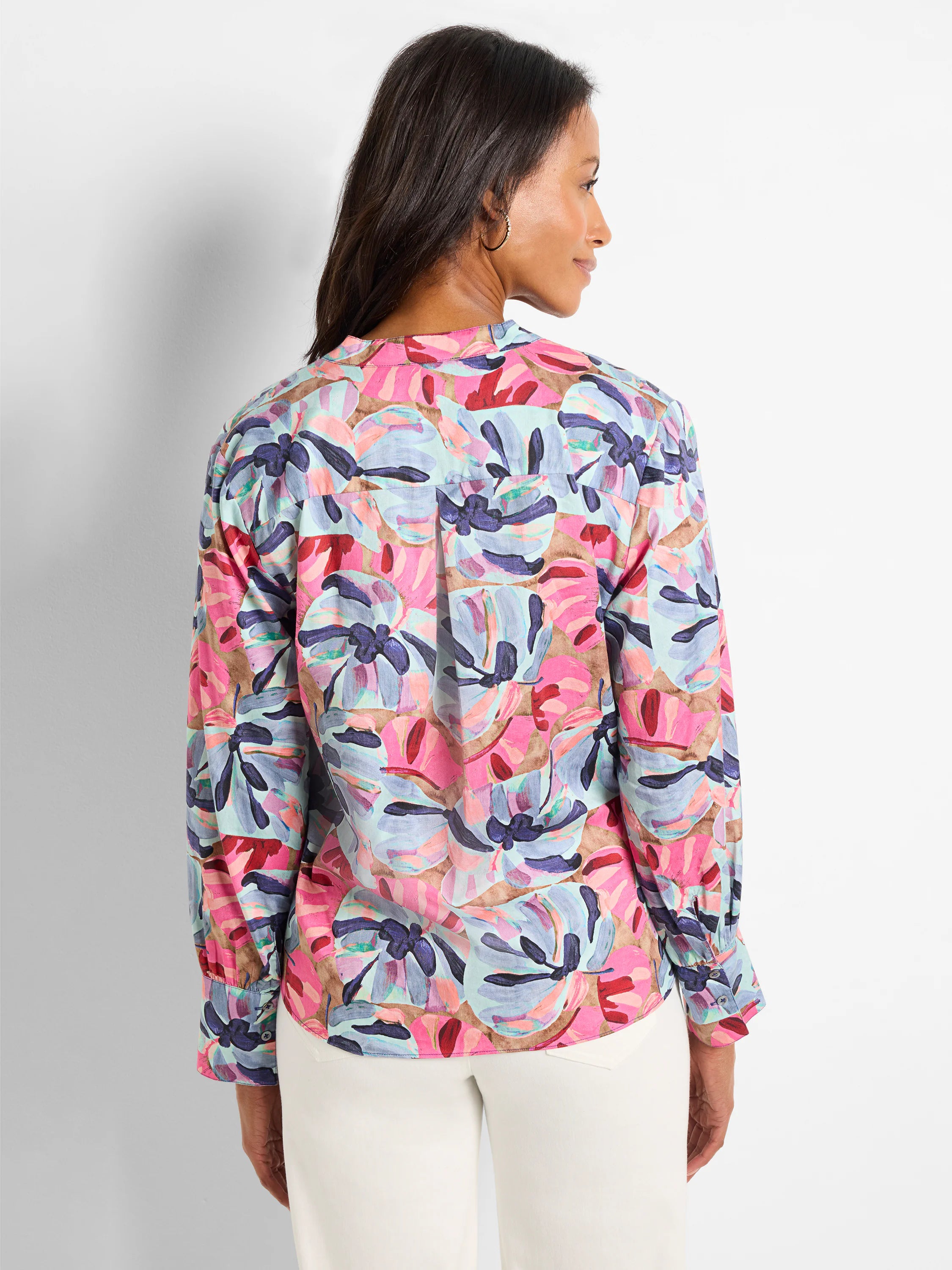 Pink, blue, and purple abstract floral print woven top with long sleeves and button cuffs. Back view shown.