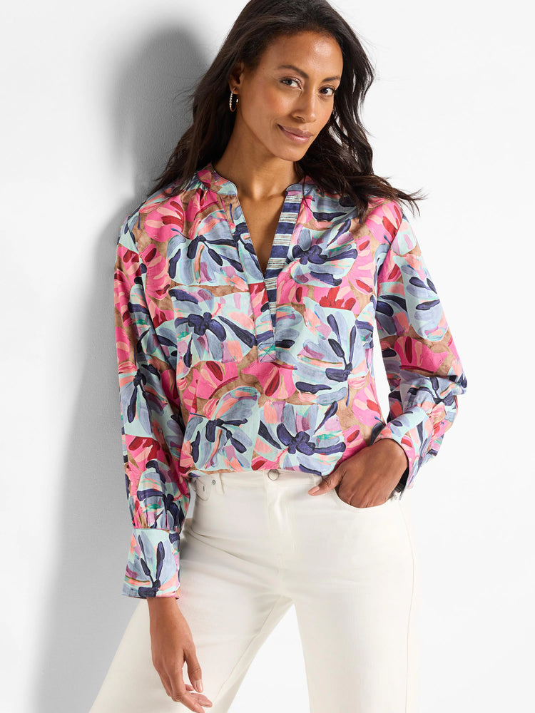 Pink, teal, blue, and brown abstract floral print woven top. Long sleeves, v-neck with striped detail.