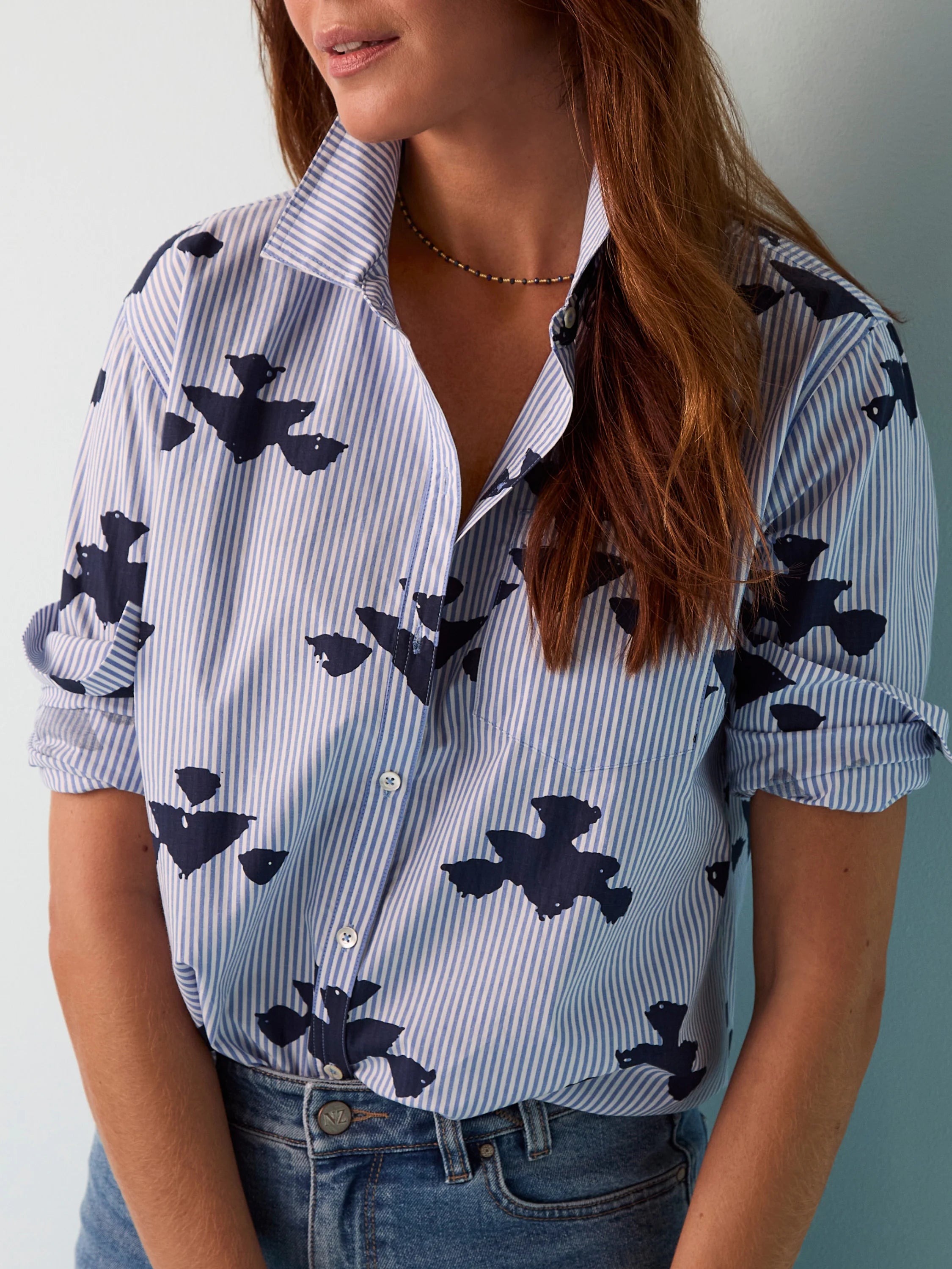 Blue and white striped woven shirt. Dark blue stamped bird pattern.  Button front. Rolled sleeves.