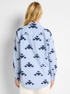 Blue and navy shirt.  Light blue stripes with a repeated navy stamped pattern. Long sleeves, collared.