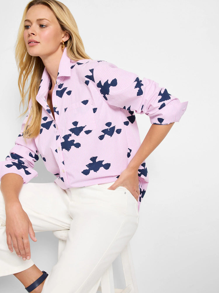 Pink shirt with thin white stripes and dark blue stamped abstract shapes. Long sleeves, button front.