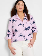 Pink and navy blue button-down shirt.  Thin pink stripes and dark blue stamped abstract shapes. Long sleeves.