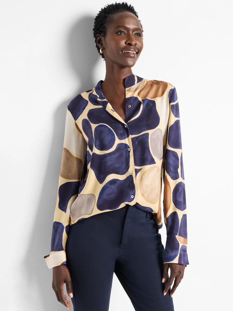 Beige shirt with dark blue, brown, and gray abstract pebble print. Long sleeves, button front.