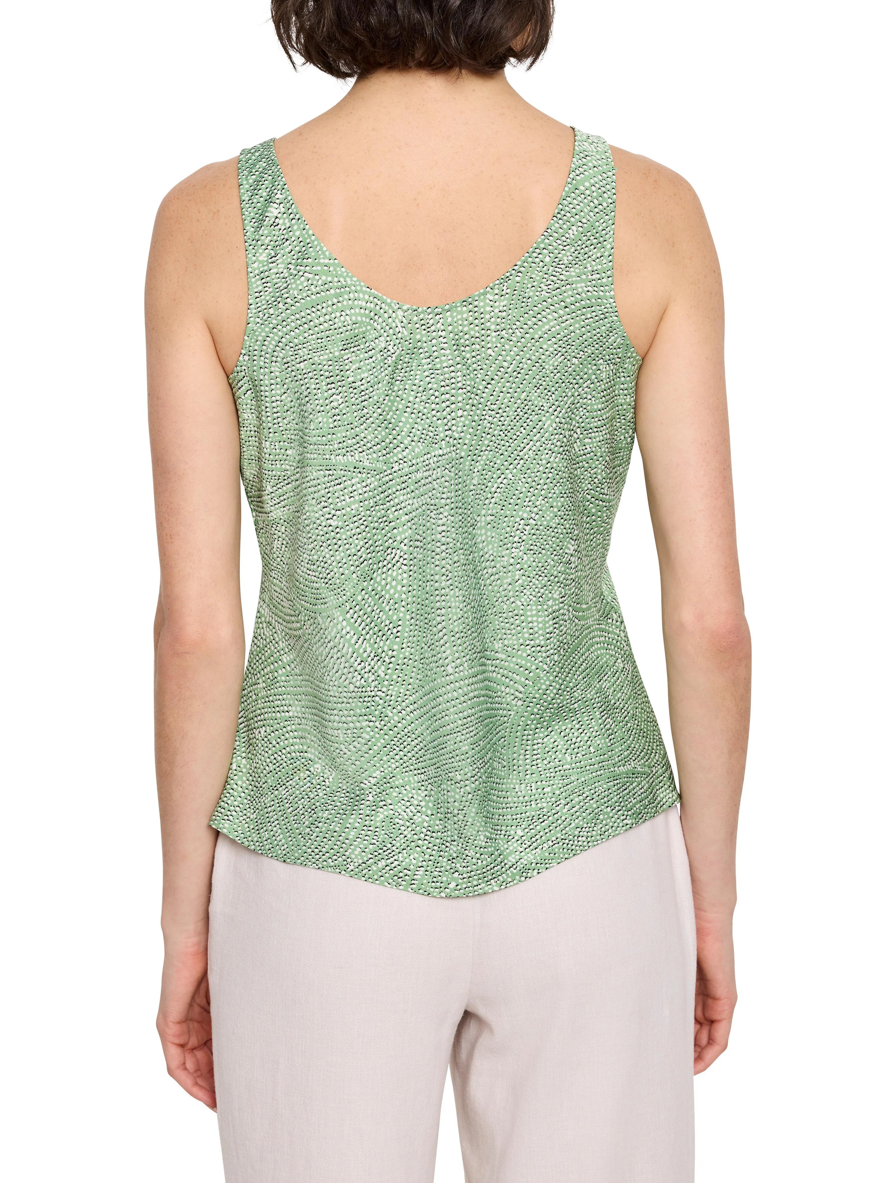 Back view of light green sleeveless top. Swirling, speckled pattern in black and white.
