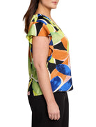 Black top with lime green, orange, and blue abstract print. Flutter sleeves.