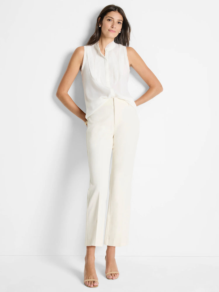 Off-white sleeveless woven top with a mock collar and subtle pleats.