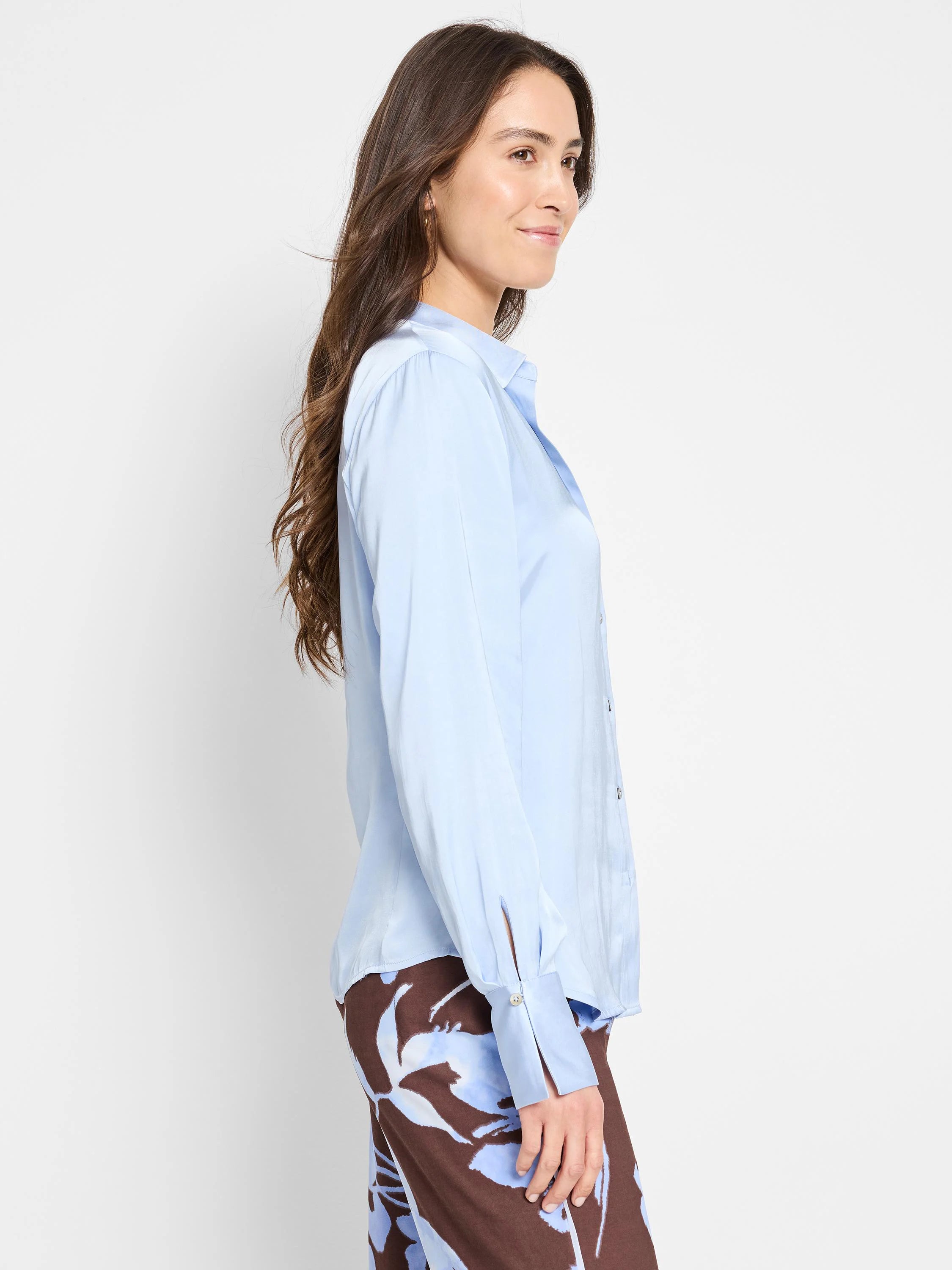 Light blue, long-sleeve collared shirt.  Button front, slightly wrinkled fabric.