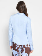 Light blue, long-sleeved collared shirt.  Cuffs and curved yoke.  Back view.