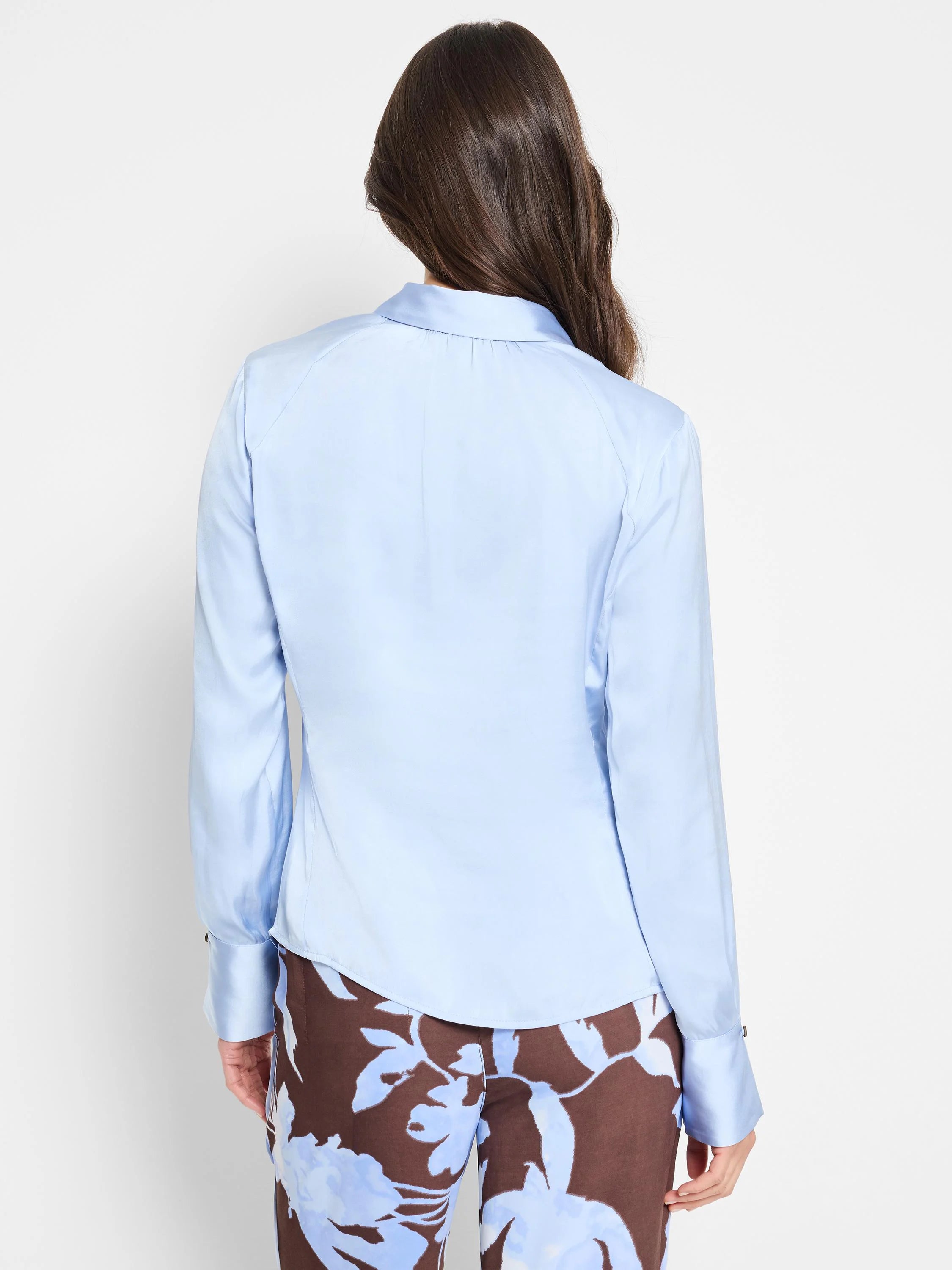 Light blue, long-sleeved collared shirt.  Cuffs and curved yoke.  Back view.