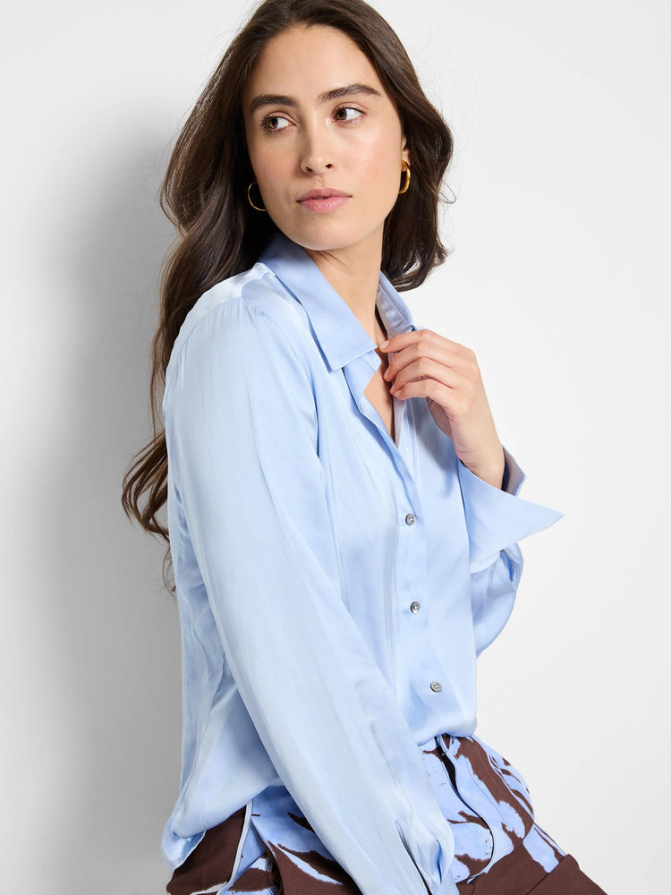 Light blue, long-sleeved collared shirt. Glossy, crinkled texture. Button front.