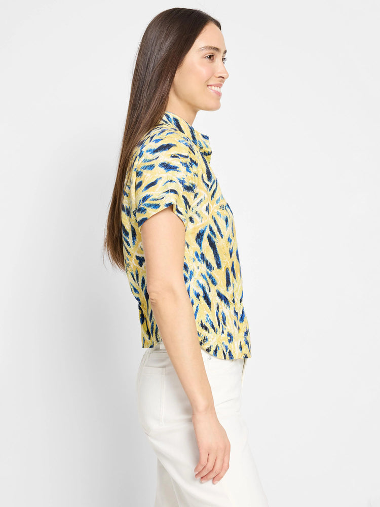Yellow short-sleeved shirt with blue abstract print. Collared, button-front.