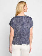 Navy blue short-sleeved top with a white abstract dot pattern.  The back view shows a relaxed fit.