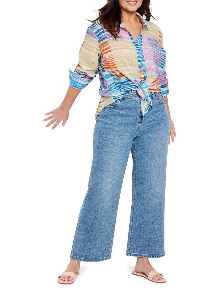Multicolored cotton shirt with orange, blue, pink, and beige stripes. Shirt is knotted at the waist. Model wears light...