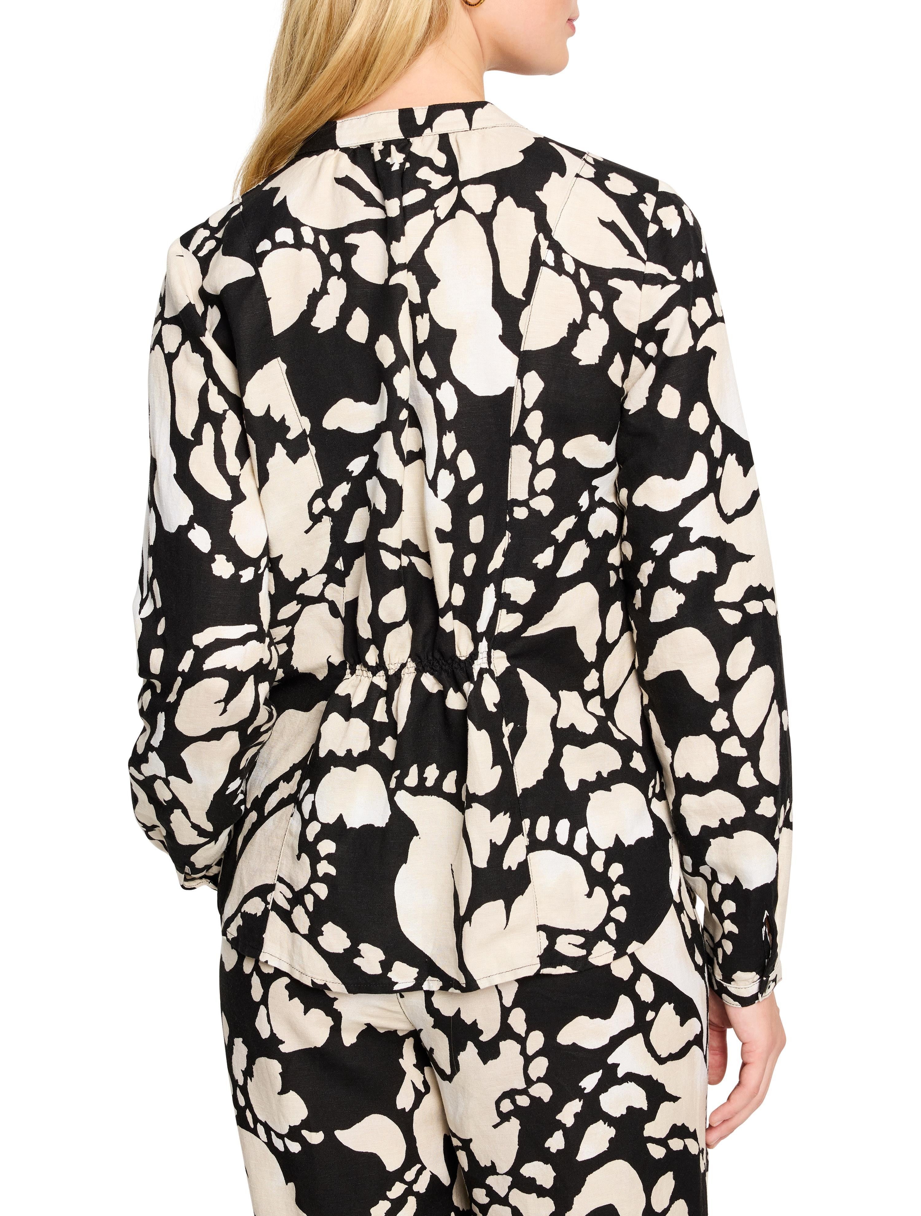 Black shirt with beige abstract print, long sleeves, and a drawstring waist.