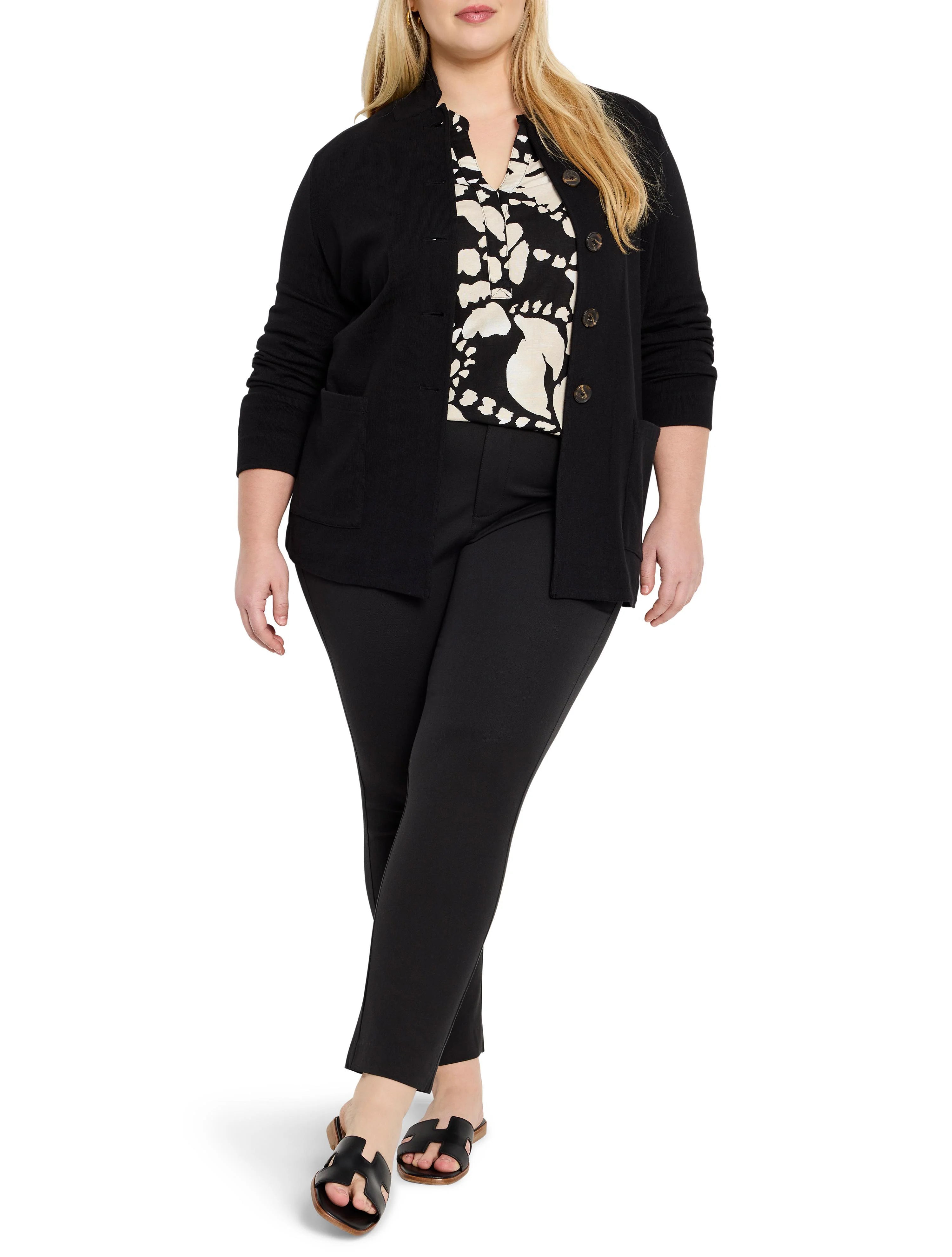 Black woven cardigan with dark buttons.  A black and cream patterned top is visible underneath.