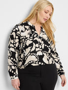 Black long-sleeve shirt with beige abstract print, V-neck.
