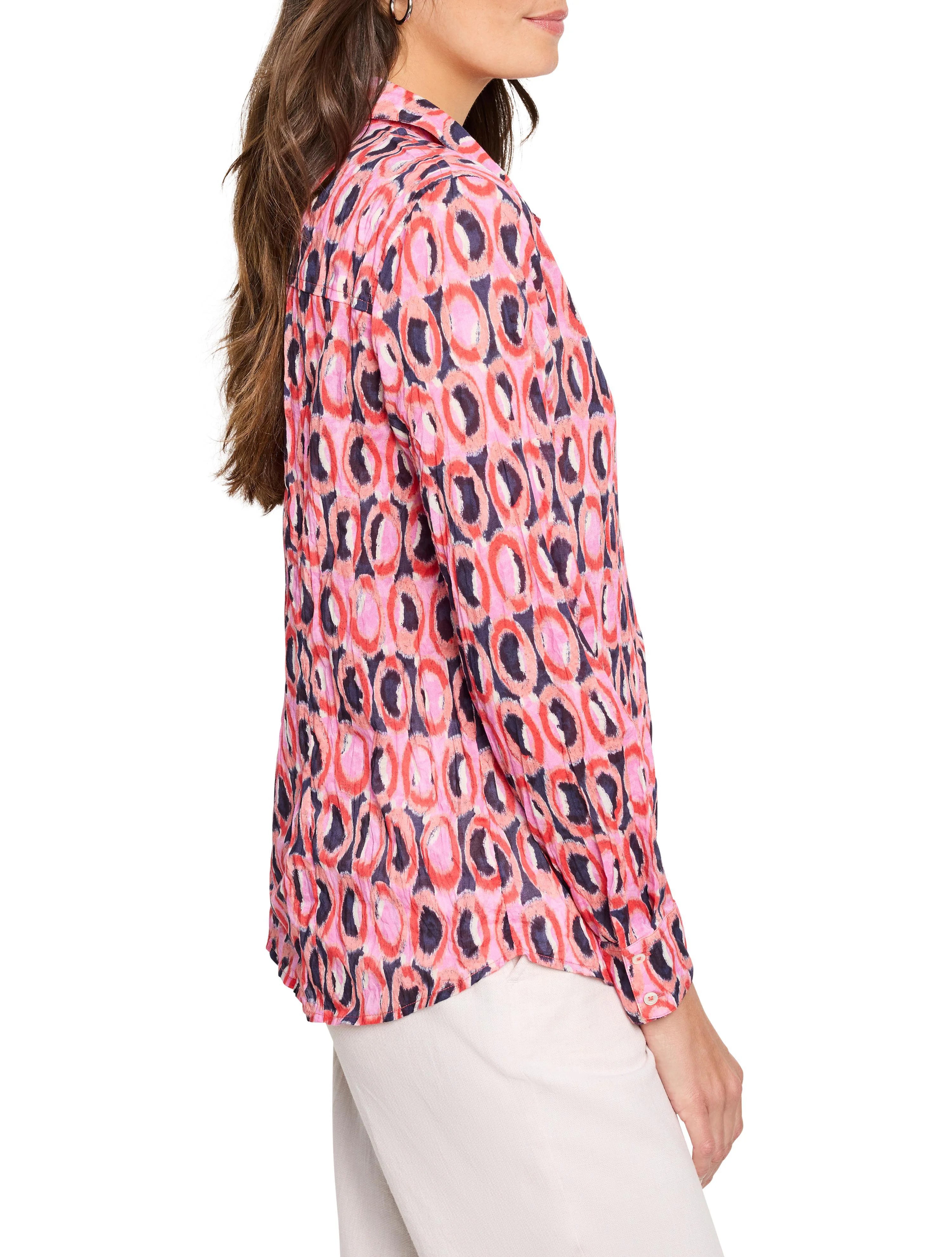 Pink, red, and dark blue Ikat-patterned cotton shirt.  Long sleeves, collared.  Circles are the main design element.