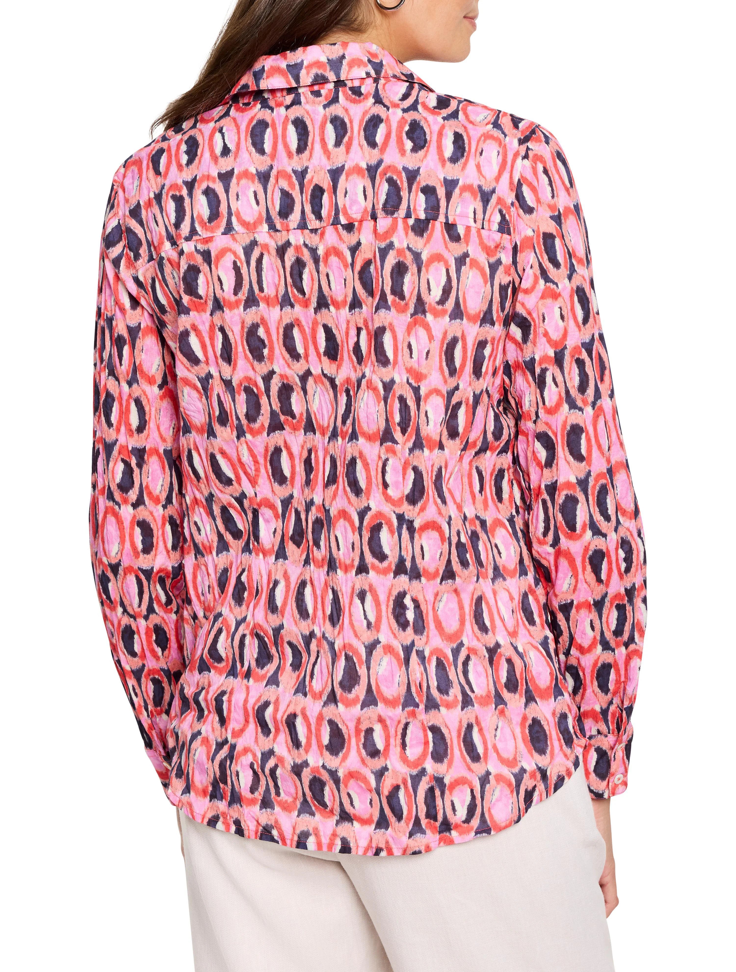 Pink, red, and dark blue ikat ring pattern on long-sleeve collared shirt.  Cotton fabric.