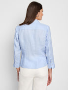 Light blue, three-quarter sleeve shirt;  tie front detail; button cuffs; shown from the back.
