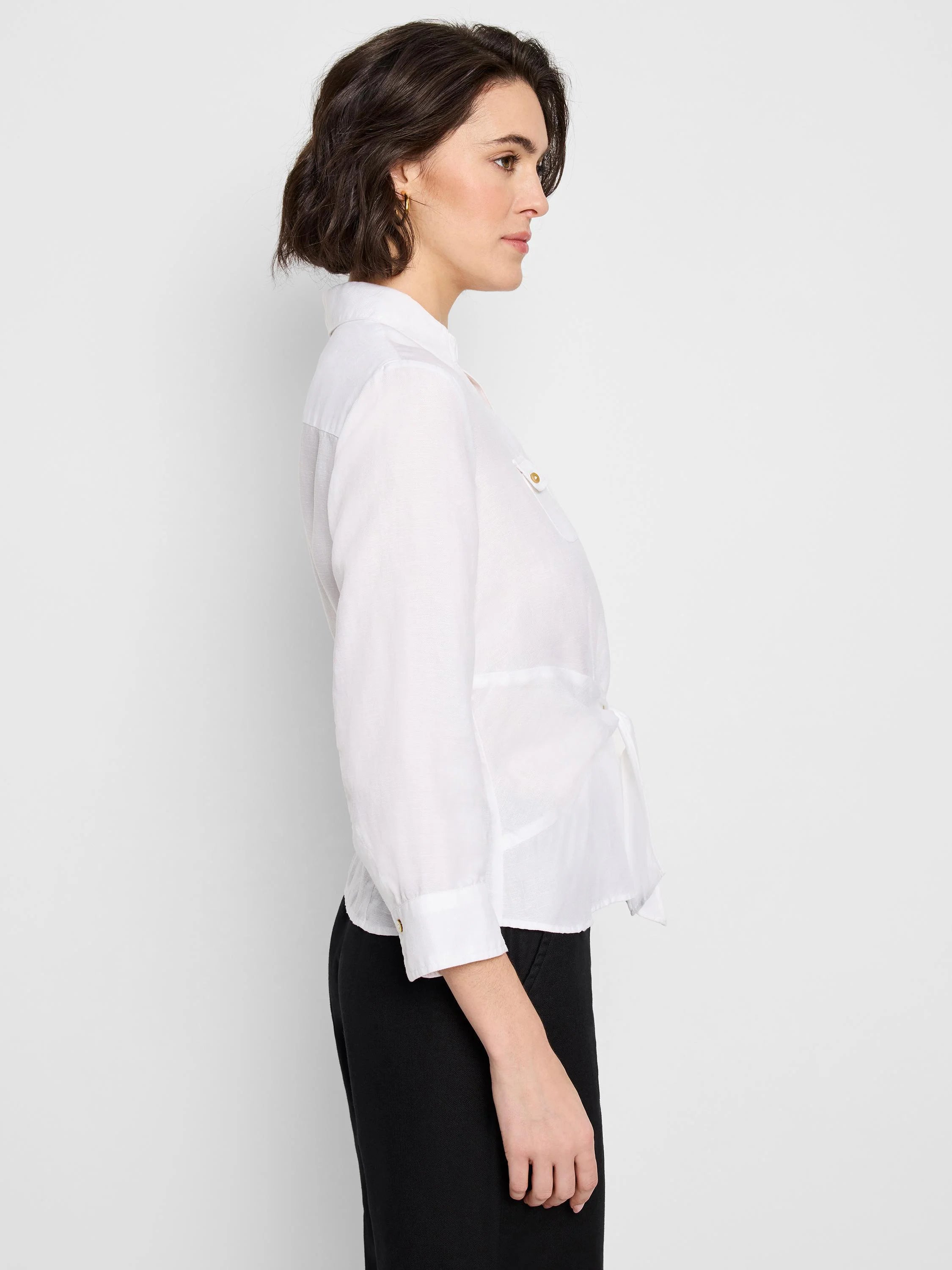 White shirt with three-quarter sleeves, tied at the waist.  Features gold buttons.