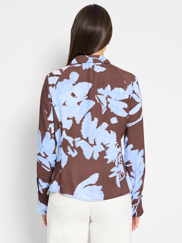 Brown long-sleeve top with light blue abstract floral print. Back view.