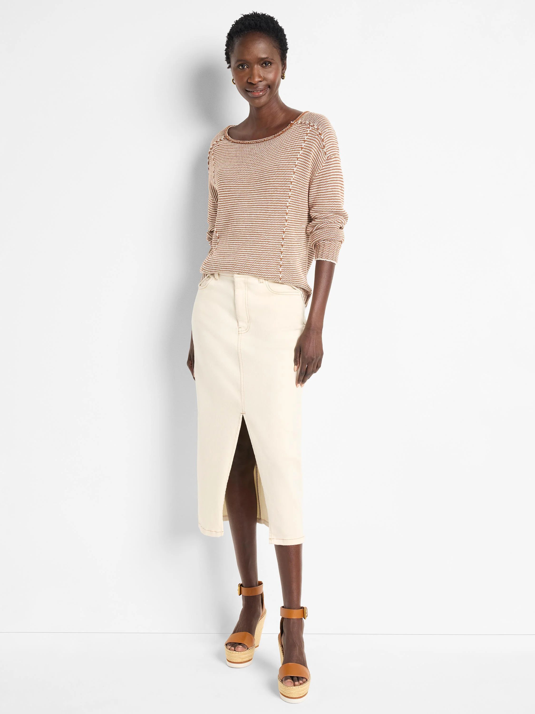 Off-white denim midi skirt with a front slit.  Features visible seams.