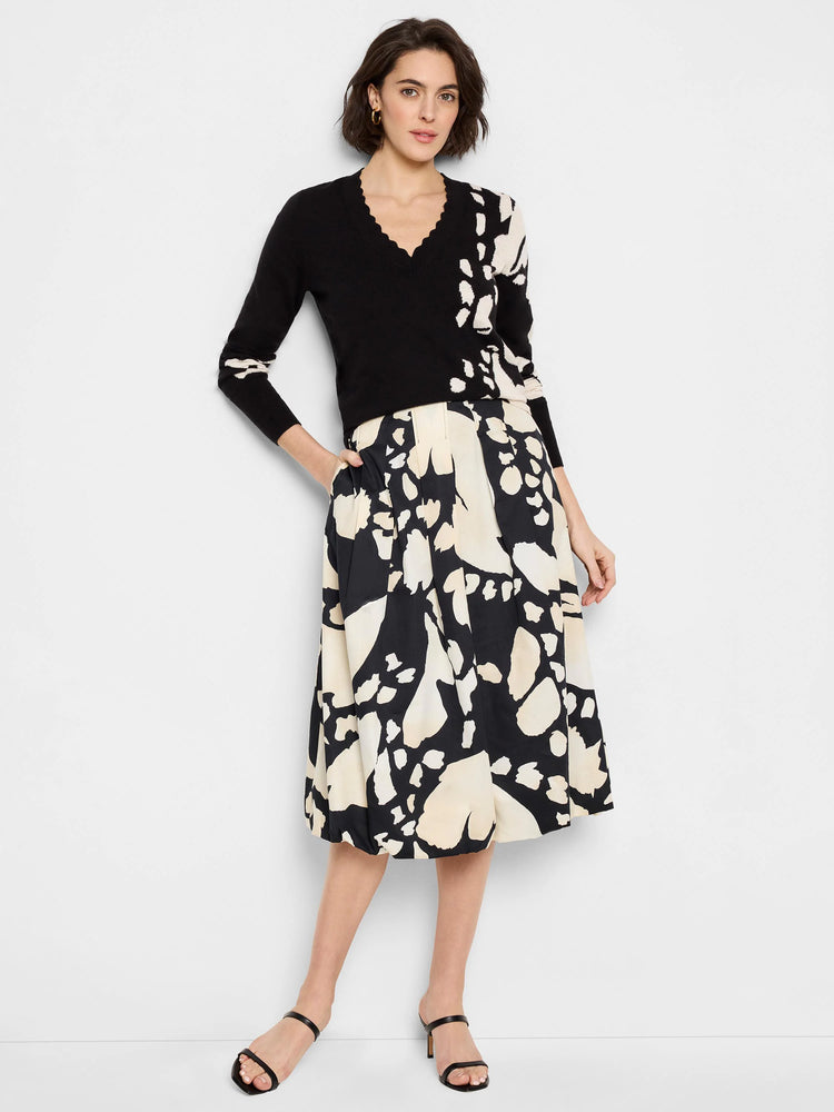 Black midi bubble skirt with an abstract beige and black print. Pleated detailing.